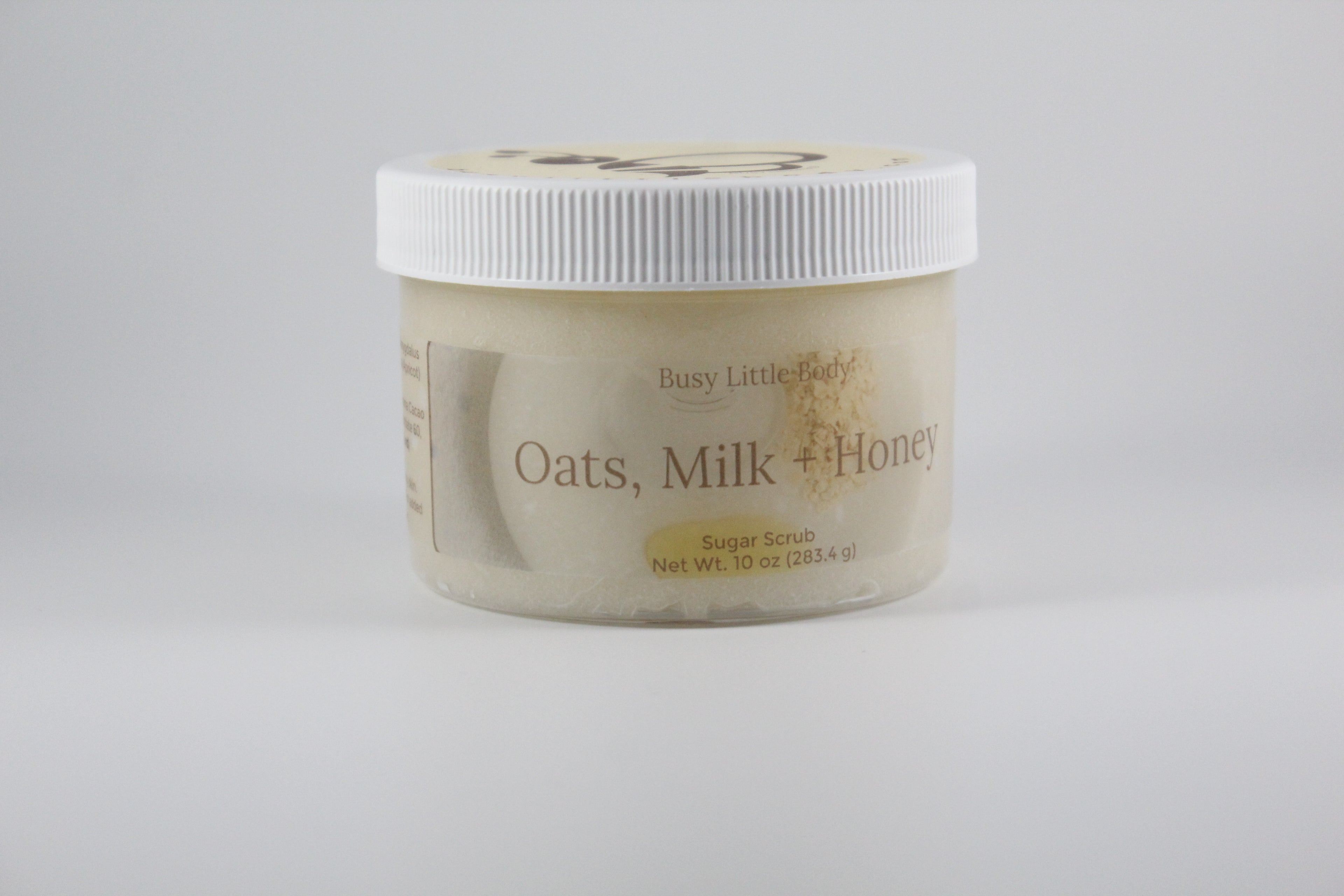 Jar of Busy Little Earth Oats, Milk + Honey Sugar Scrub on a light gray background