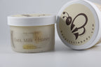 Jar of 'Oats, Milk + Honey' sugar scrub with a visible brand logo on a light background