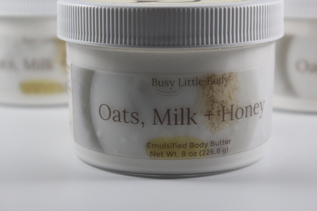Jar of 'Oats, Milk + Honey' emulsified body butter with 'Busy Little Body' branding.