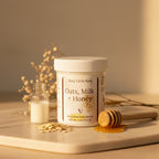 Jar of 'Oats, Milk + Honey' body butter by Busy Little Body on a gray background