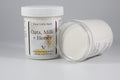 Two containers of 'Oats, Milk + Honey' emulsified body butter by Busy Little Body on a gray background.
