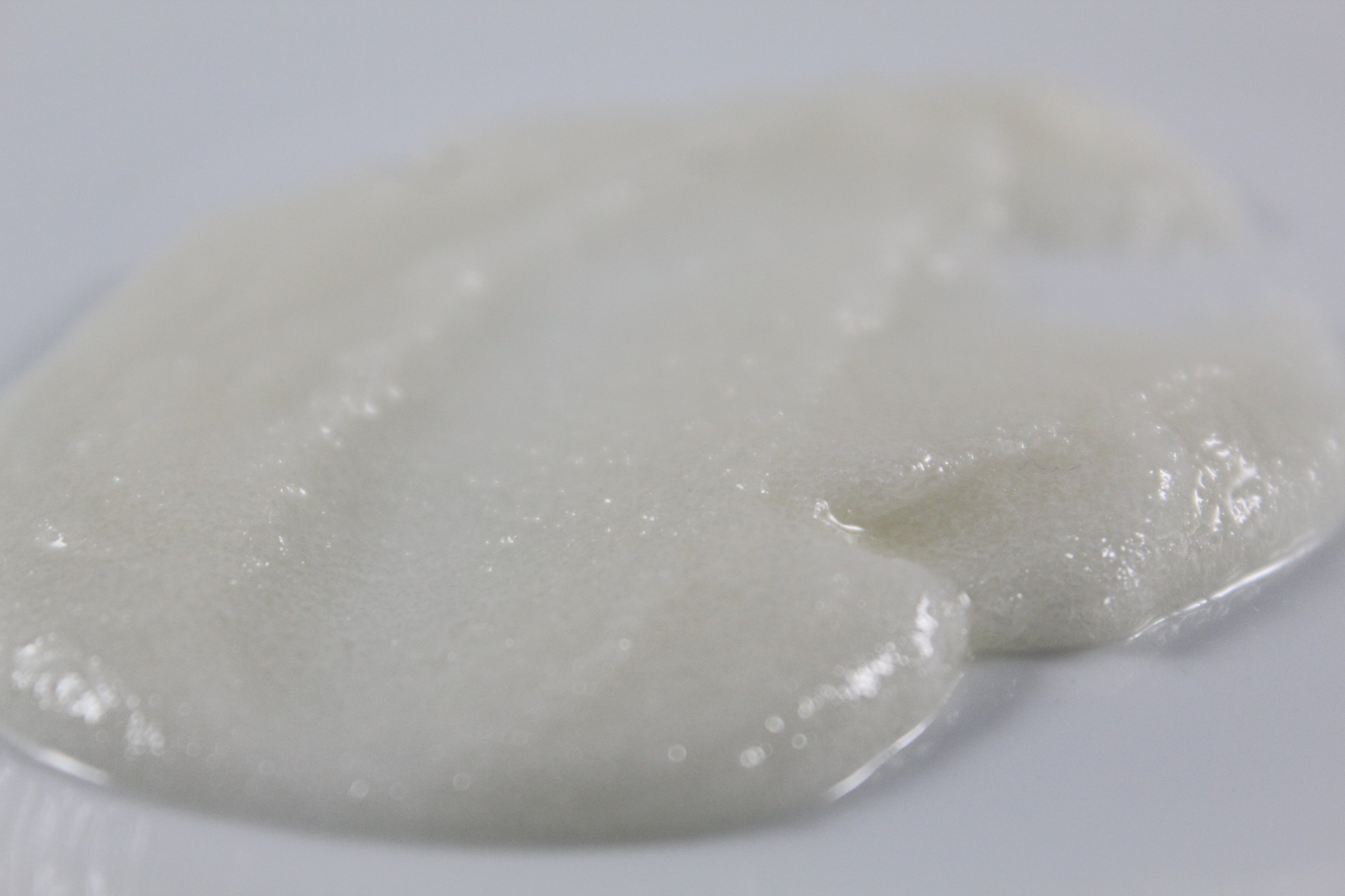 White, sugar scrub on a white background