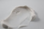 Close up of body butter cream. Texture is smooth on a white table.