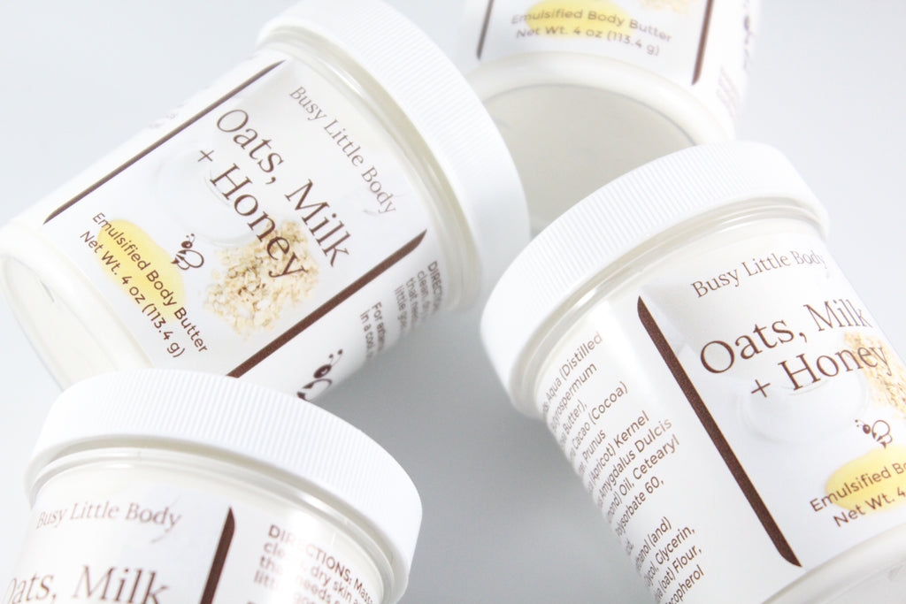 Jars of 'Oats, Milk + Honey' body butter from Busy Little Body on a light background