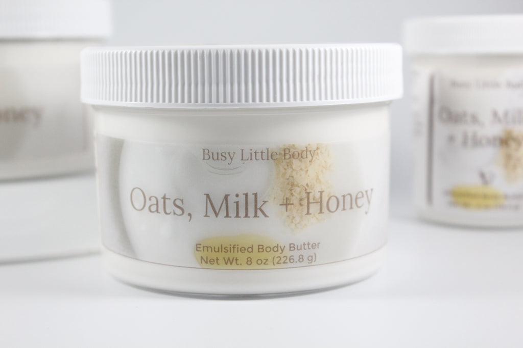 Jar of 'Oats, Milk + Honey' emulsified body butter by Busy Little Body on a white background.