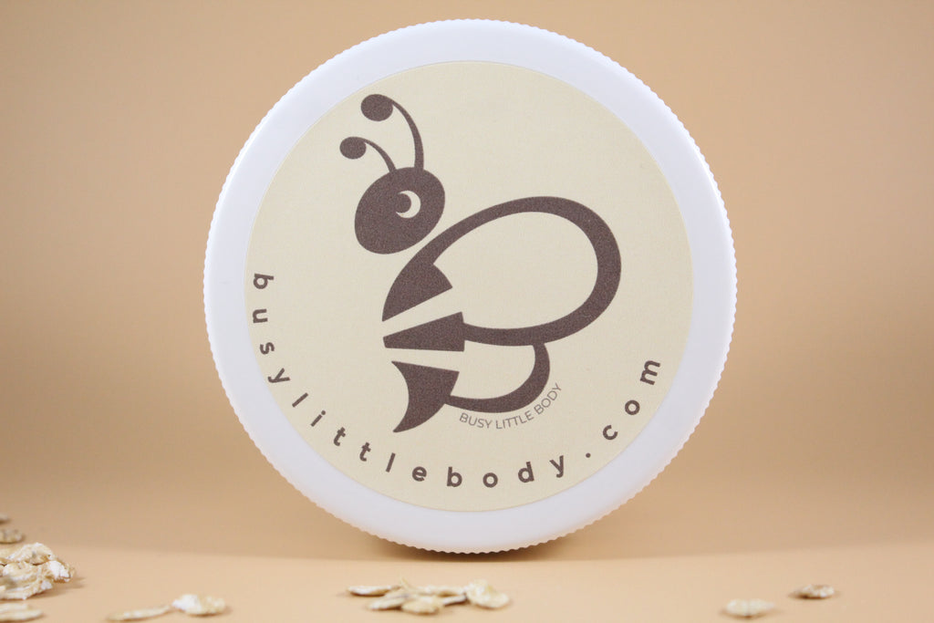 Round container with a bee logo and 'busylittlebody.com' text on a beige background