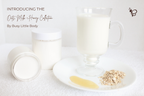Glass of milk with oats and honey on a white surface, featuring 'Oats, Milk & Honey Collection' by Busy Little Body.